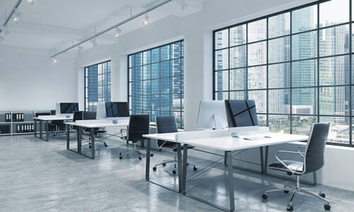 Workplaces in a bright modern loft open space office. Tables are equipped with modern computers; book shelves. Singapore panoramic view. A concept of a high quality consulting services. 3D rendering.