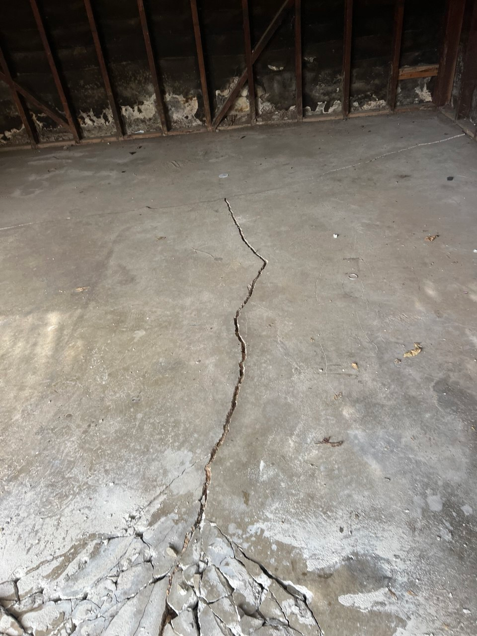 Wide view of significant cracked garage concrete failure